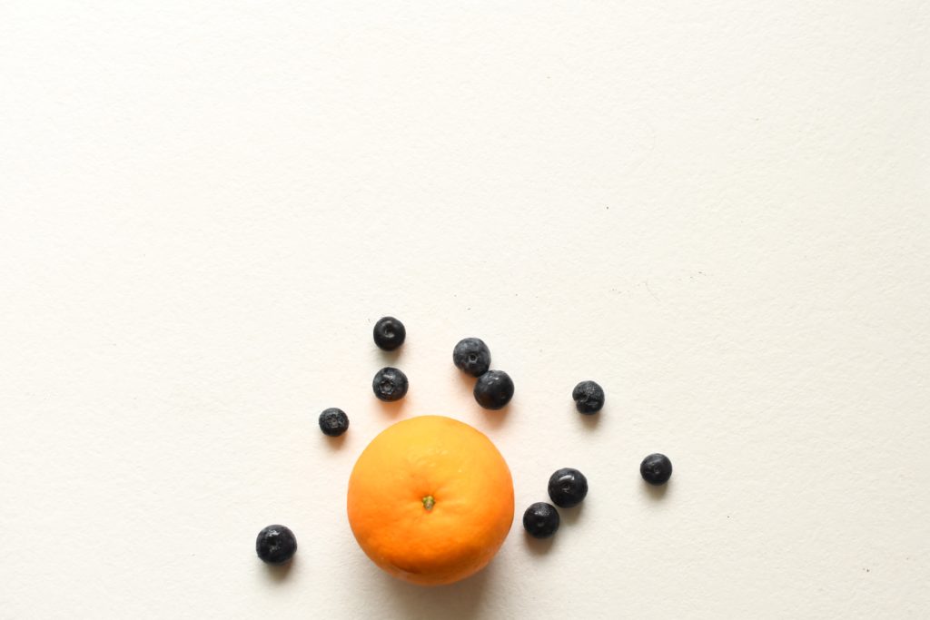 Orange and blueberries next to each other to illustrate where you stack up with your marketing positioning