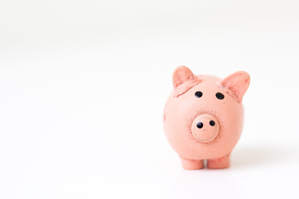 Piggy bank image on white background to illustrate creating a marketing plan on a budget.